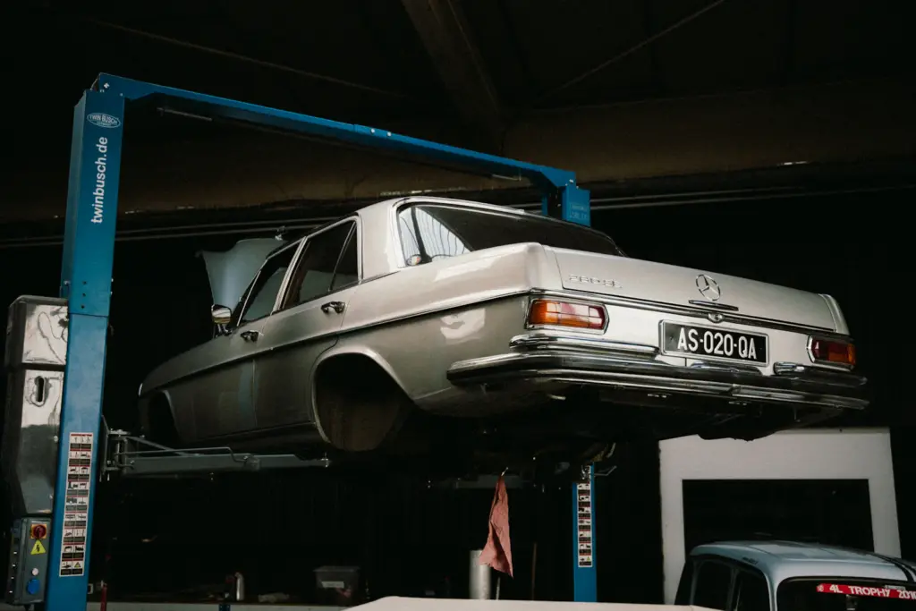 Car raised on a lift in a garage