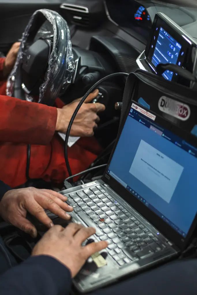 Diagnostic laptop connected to a car